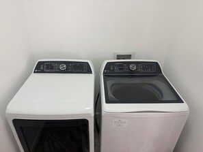 Two front-loading washing machines in a laundry room.