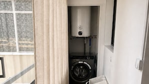 A laundry room with a washing machine, a dryer, and a water heater. - Cozy, air-conditioned 2-bedroom apartment, Toulon (Toulon)