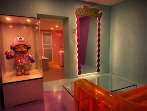 A room with a pink robot figure, a neon sign saying 'You are Beautiful', and a glass railing. - Paradise Suite—Private Jacuzzi: A Romantic Retreat Between Thionville and Luxembourg (Serémange-Erzange)