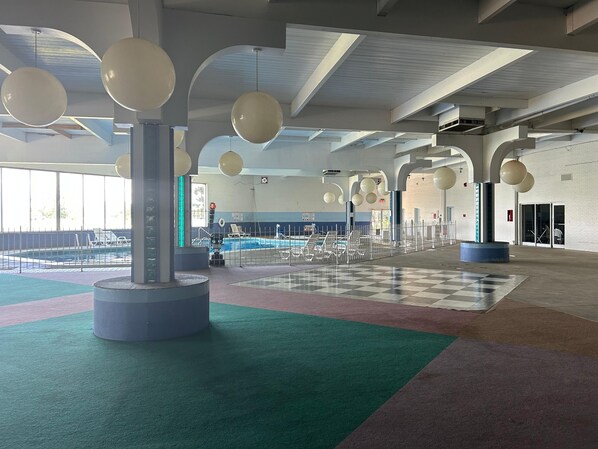 An indoor swimming pool area with multiple lanes, a checkered floor, and hanging spherical light fixtures. - Your Relaxing Silver Beach Escape in Saint Joseph - Benton Harbor (Benton Harbor)