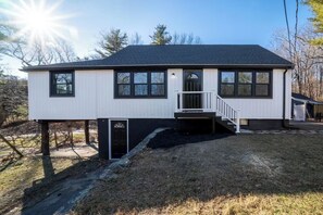 A two-story house with a front porch, a small staircase, and a garage.