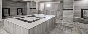 A modern bathroom with a large central island, a built-in shower, and a vanity with a mirror. - Green Moringa Termal Otel (Termal)