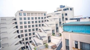 A multi-story building with a modern architectural design, featuring balconies and a central courtyard. - Fabulous 1-bedroom apartment (Nairobi)