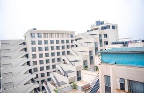 A multi-story building with a modern architectural design, featuring balconies and a central courtyard. - Fabulous 1-bedroom apartment (Nairobi)