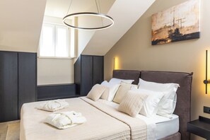 Une chambre à coucher moderne avec un grand lit, un tableau au mur et une lucarne.