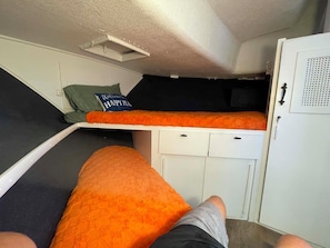 A bunk bed with a pillow that says 'Welcome to Happy Place.'