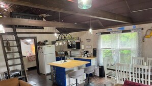 A compact living space with a kitchen, dining area, and a cozy seating area. - Private Cabin on the lake with your own dock. (Decatur)