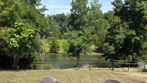A fire pit with four chairs arranged around it in an outdoor setting. - Private Cabin on the lake with your own dock. (Decatur)