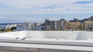 A hotel rooftop with a view of the sea and mountains. - Heart of Cabo|3BR Oasis|Rooftop Spa|Poolside (Cabo San Lucas)