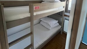 A bunk bed with a ladder, a window with curtains, and a door leading to another room. - Apartment for 6 people at the base of the slopes: L'Ecrin des Neiges (Chamrousse)