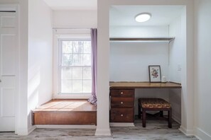 A room with a window, a desk, a chair, and a small bench. - Sleeps 18 Riverfront Getaway with Game Room & Deck (Valdosta)