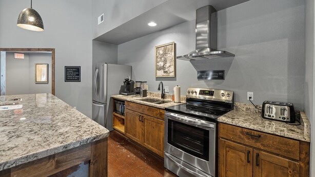 A kitchen with granite countertops, stainless steel appliances, wooden cabinets, and a stainless steel range hood. - My Place in Powder House Pass, Paved Roads, AC, Hot Tub! (Lead)
