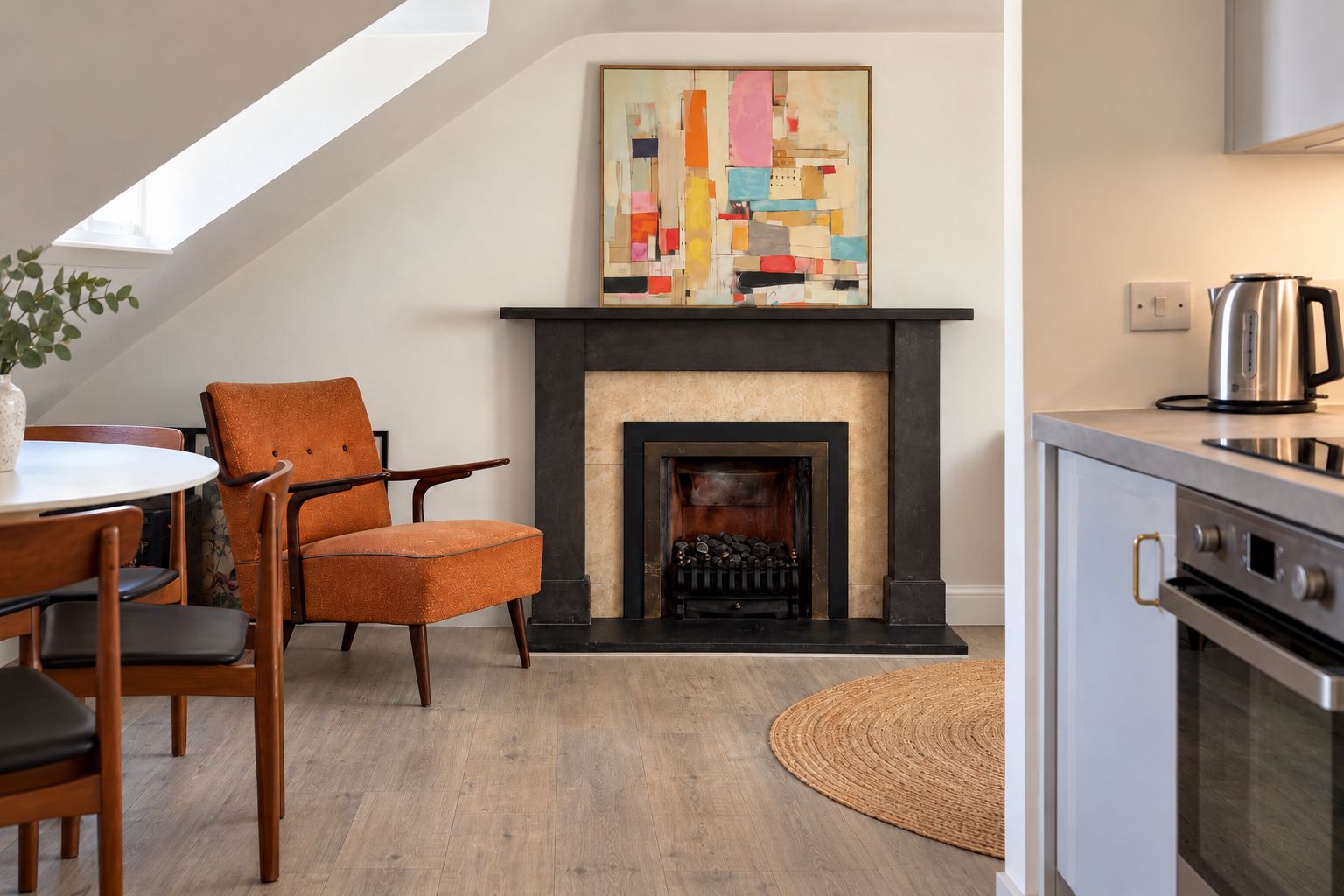 Cozy living space with fireplace, dining nook, and modern kitchen