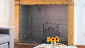 A fireplace with a brick interior and a yellow mantel. - [Historic Center] Elegant one-bedroom apartment with a balcony (Brescia)