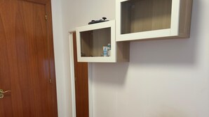 A room with a bed, a wooden wardrobe, and a white cabinet with a shelf. - Barcelona Room – Temporary Sublet €40/day: 10% discount for longer stays (Spain)
