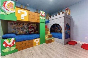 A children's bedroom with two bunk beds, each decorated with Mario and Luigi characters. - NEW Luxury 14BR Estate - Sleeps 36 - Theater/Games (Davenport)