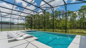 A swimming pool with lounge chairs and a greenhouse structure. - NEW Luxury 14BR Estate - Sleeps 36 - Theater/Games (Davenport)