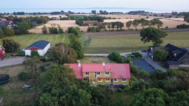 Een landelijk gelegen bezit met een groot huis, een schuur en zonnepanelen.