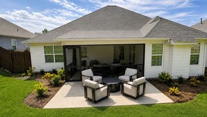 A house with a covered patio area featuring outdoor furniture. - Exclusive Masters Retreat — Just Minutes from Augusta National (North Augusta)