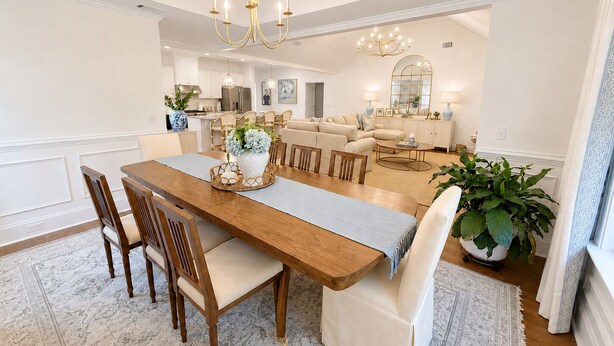 A spacious dining area with a wooden table, chairs, and a chandelier. - Exclusive Masters Retreat — Just Minutes from Augusta National (North Augusta)