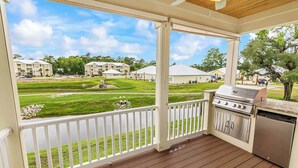 A covered outdoor area with a grill and a view of a residential neighborhood. - Hallandale Hideaway, luxury townhome, sleeps 8 with POOL. (Murrells Inlet)