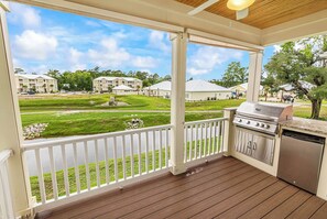 A covered outdoor area with a grill and a view of a residential neighborhood. - Hallandale Hideaway, luxury townhome, sleeps 8 with POOL. (Murrells Inlet)