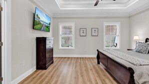 A bedroom with a bed, dresser, ceiling fan, and artwork on the wall. - Hallandale Hideaway, luxury townhome, sleeps 8 with POOL. (Murrells Inlet)