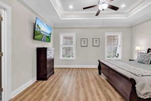 A bedroom with a bed, dresser, ceiling fan, and artwork on the wall. - Hallandale Hideaway, luxury townhome, sleeps 8 with POOL. (Murrells Inlet)