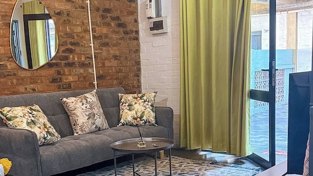 Ein möbliertes Wohnzimmer mit Sofa, Couchtisch und kleinen Beistelltisch.