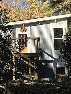 A two-story building with a staircase leading to a landing, surrounded by trees. - Retromoderninthewoods steps from the best trails in the Linville gorge wildernes (Newland)