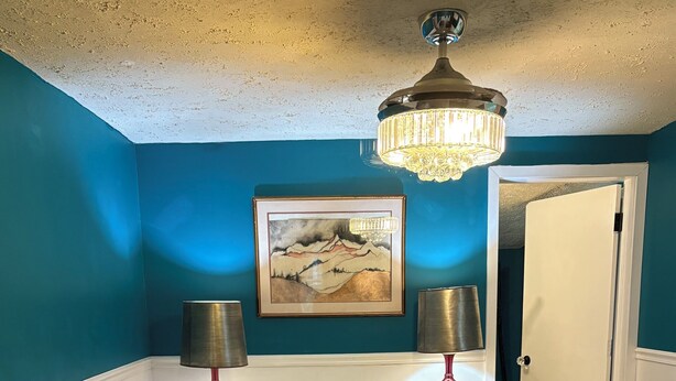 A bedroom with a bed, two bedside lamps, a painting, and a door leading to another room. - Peaceful Vintage Charm in North Asheville (Asheville)