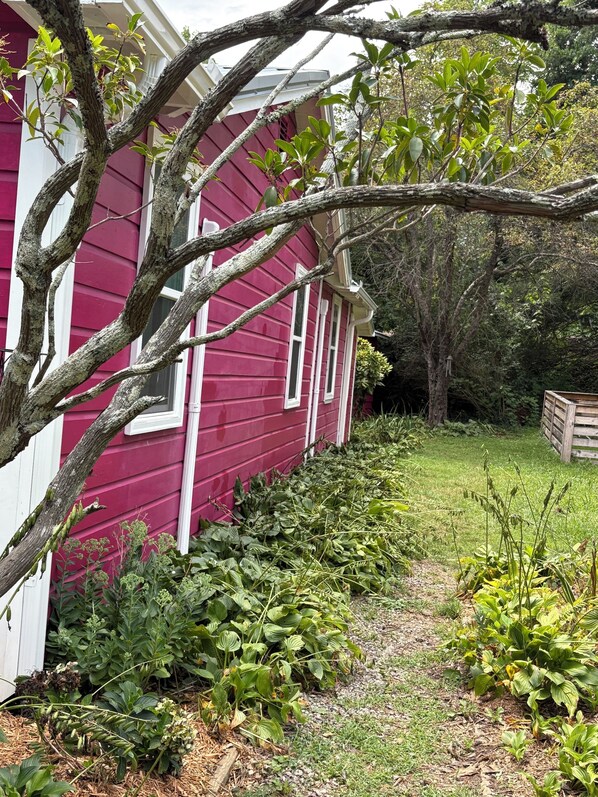 A red house with a garden path leading to the front door. - Peaceful Vintage Charm in North Asheville (Asheville)