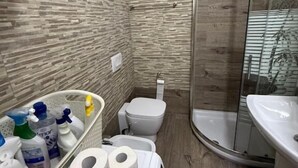 A bathroom with a shower, toilet, and sink. - Coco Apartment (Radhimë)