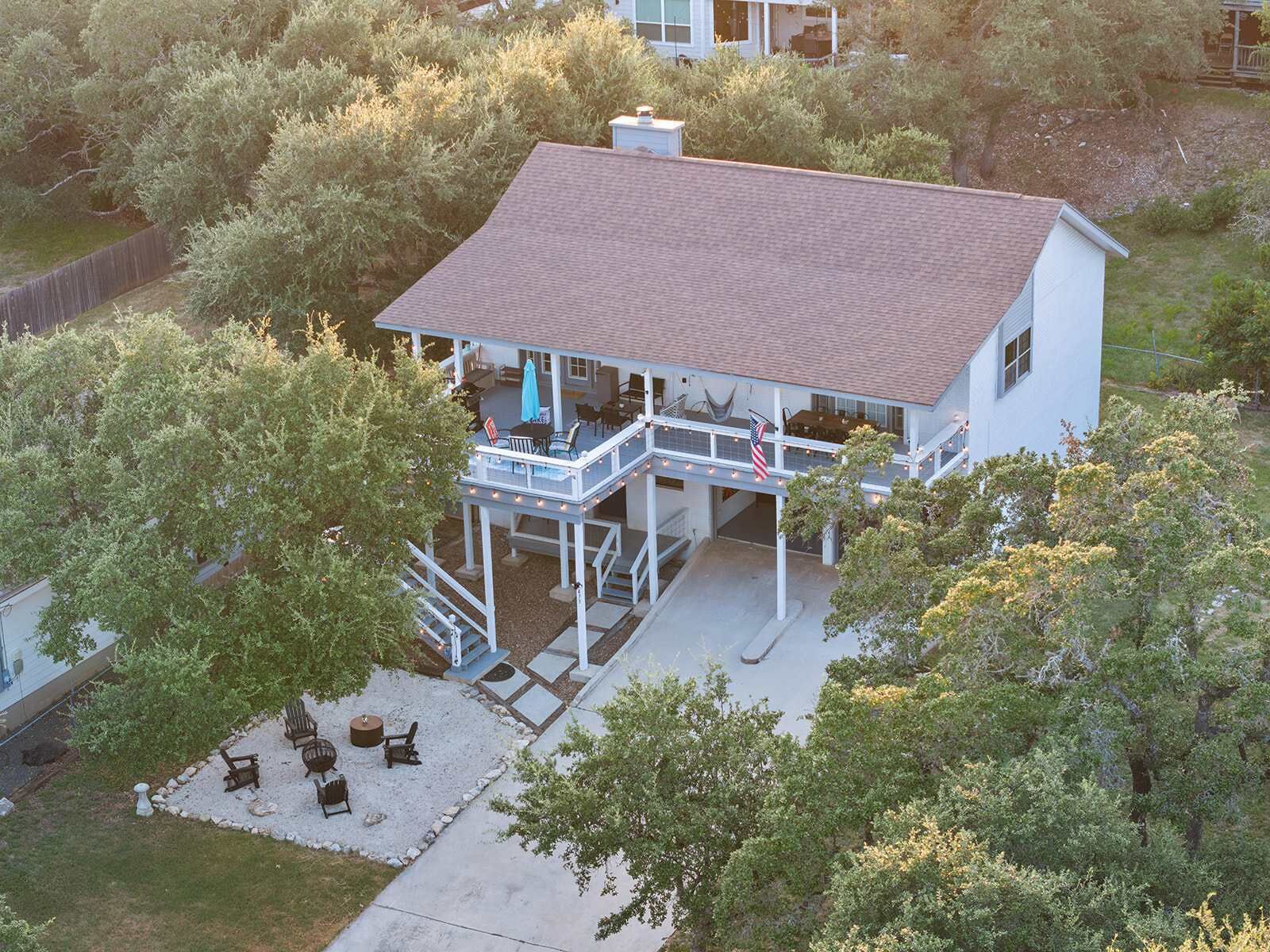A two-story house with a covered patio and outdoor seating area.
