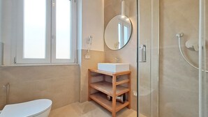 A modern bathroom with a toilet, sink, and shower. - The Two Olive Trees - North (Campo nell'Elba)