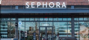 A Sephora store with a glass facade and a brick wall in the background. - Fantastic 1-Bedroom Condo in Southend! (CHARLOTTE)
