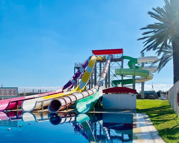 A water park with multiple slides and a pool.