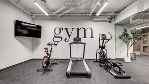 Ein Fitnessraum mit Laufband, Ergometer und Crosstrainer.