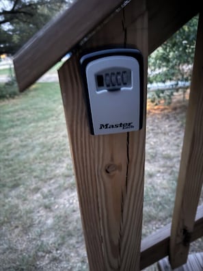 A wooden structure with a metal device labeled 'Master Lock' attached to it.