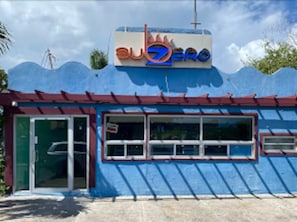 A building with a sign that reads 'subzero' and a blue exterior. - The Chique Suite - The Ultimate Urban Retreat (Kingston)