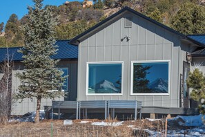 A modern two-story building with large windows, a metal roof, and a 'WELCOME' sign. - Mountain Views of the San Juans. Great outdoor living, near bike, hike and swim. (Ridgway)
