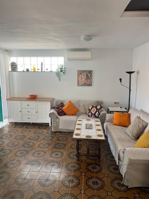 A living room with a sofa, a coffee table, a cabinet, and patterned flooring. - Two-story house in P. Andaluz/Torróx Costa. 3 bedrooms, sleeps 5, and community pool (Torróx Costa)