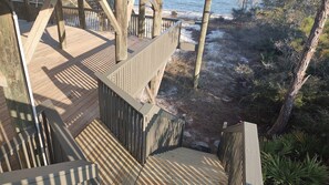A wooden deck with a view of the beach and ocean. - 4 bedroom beach front beach house (Alligator Point)