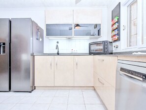 A modern kitchen with stainless steel appliances, a built-in oven, and a microwave. - Oasis 10 by Interhome (El Carmoli)