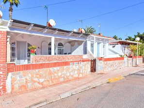 A two-story house with a stone facade, a covered porch, and satellite dishes. - Oasis 10 by Interhome (El Carmoli)