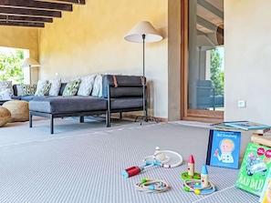 A living room with a sofa, a lamp, and children's toys on a rug. - Hort des Padri by Interhome (Marratxi)