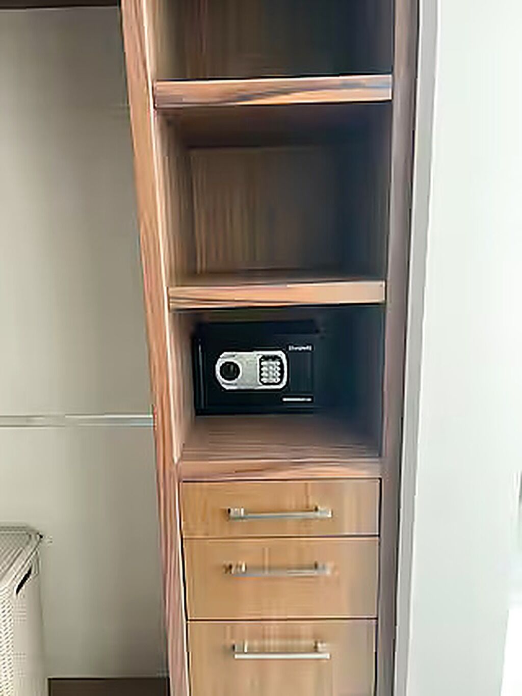Ein Holzschrank mit einem Radio auf der obersten Ablage und zwei Schubladen darunter.