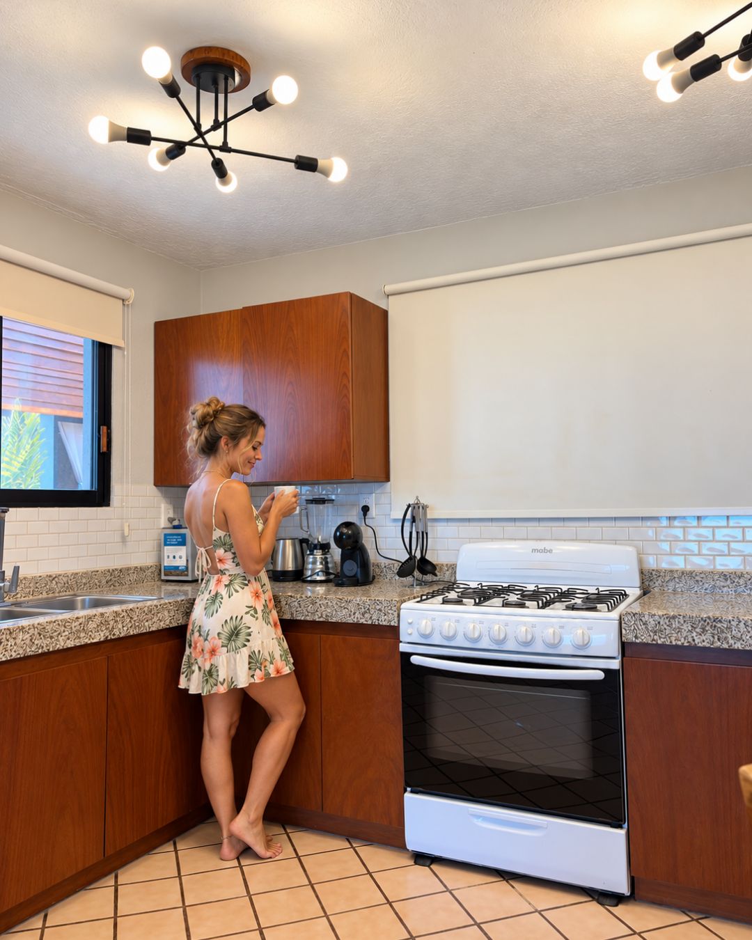 A kitchen with wooden cabinets, a white stove, and a countertop with various appliances.