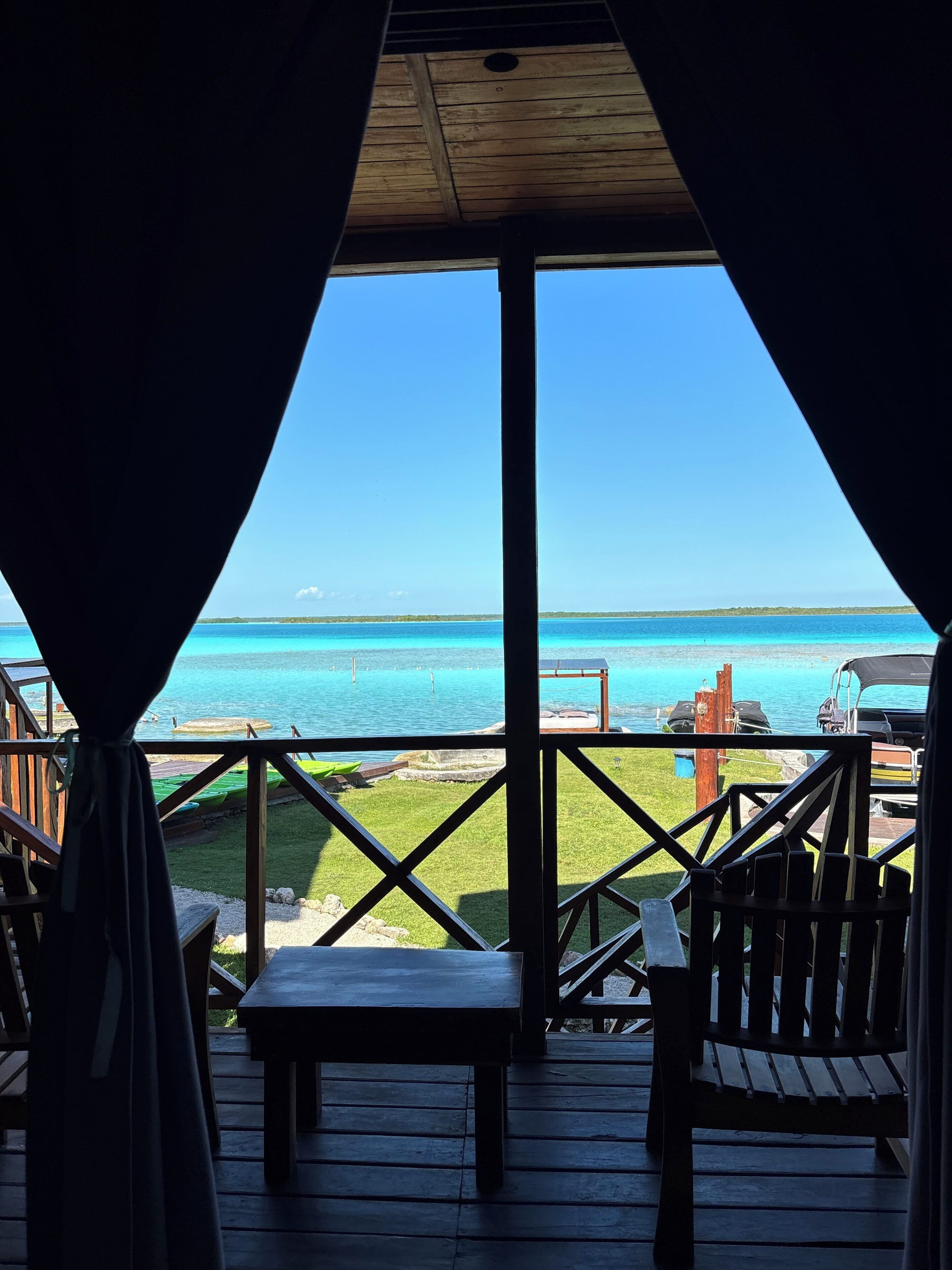 A wooden deck with a view of the ocean.
