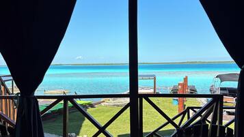 A wooden deck with a view of the ocean.